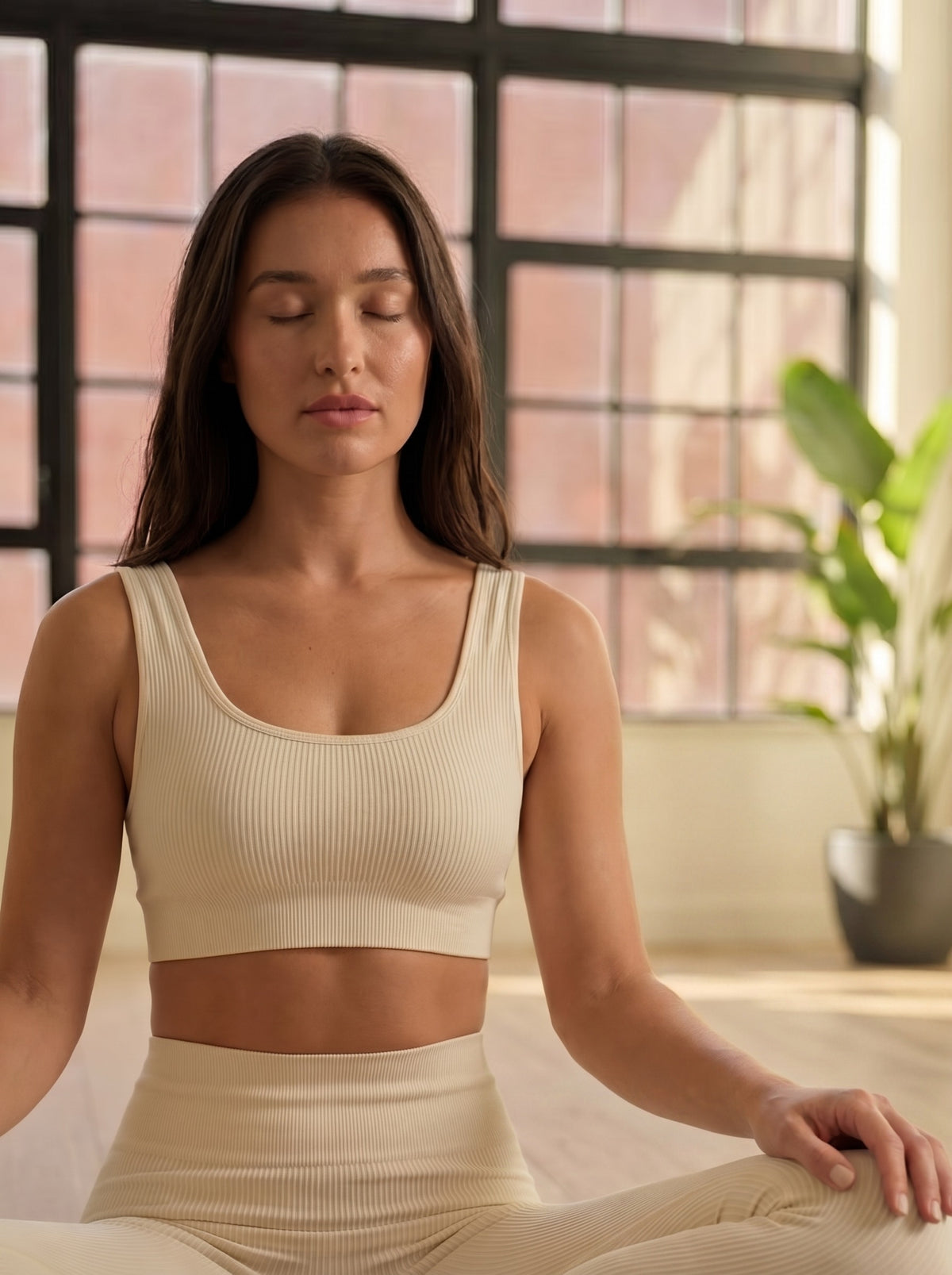 A woman on the mat, the day still loud behind her eyes